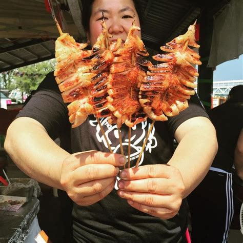 a man holding up several pieces of food in his hands