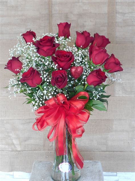 Tall and elegant, 1 dozen long roses in a white ceramic vase. | jillybudflorist