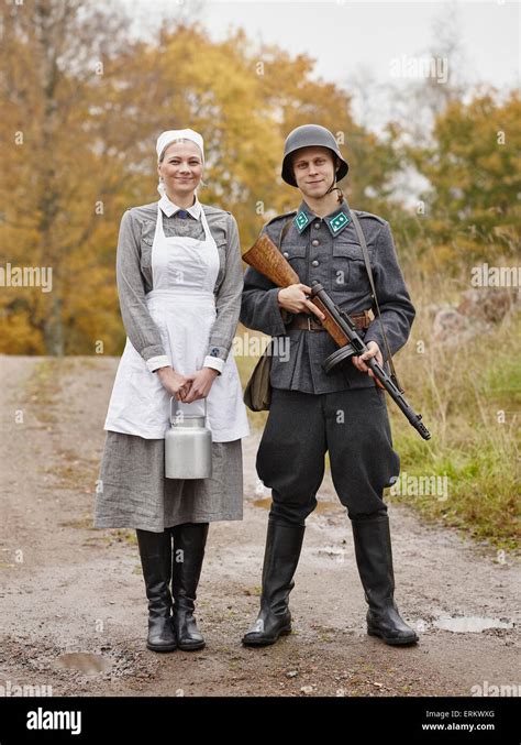 Historic costume theme World War II, Finnish soldier and the Lotta Stock Photo - Alamy