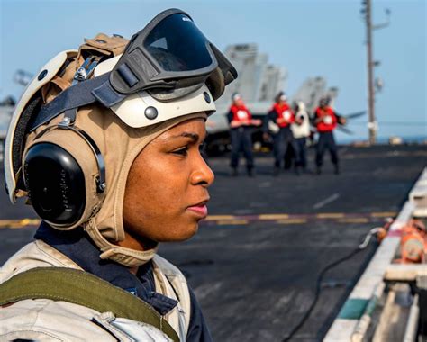 Hospital Corpsman 1st Class Samone Thorne, a medical observer, stands watch on the flight deck ...