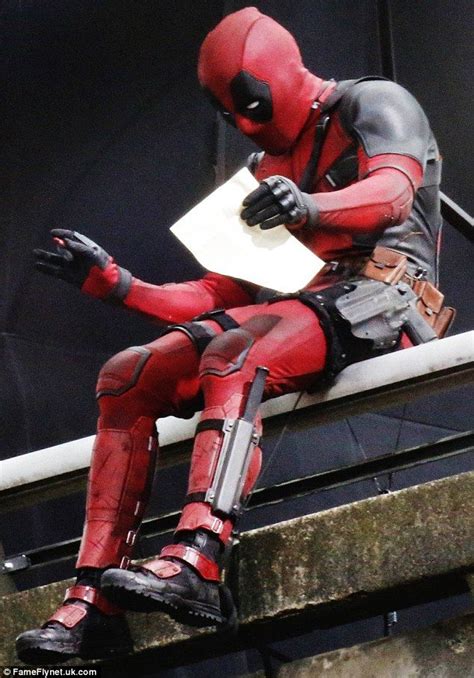 Ryan Reynolds holds letter while sitting on a bridge for Deadpool ...