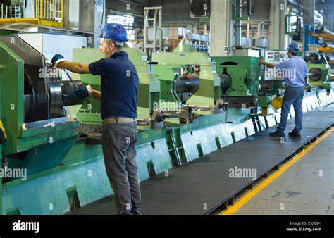 Caucasian workers working in steel factory Stock Photo - Alamy