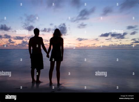 Silhouette of a couple holding hands at sunset Stock Photo - Alamy