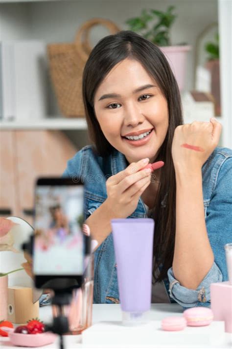 Young Asian Reviewing Cosmetic Makeup Lipstick Matte on Social Media. Stratagem. Stock Photo ...