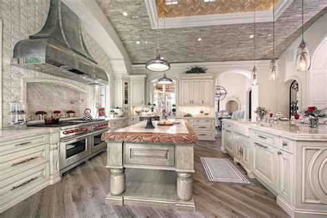 Luxury French Villa custom home kitchen with white wood and wood floors ...