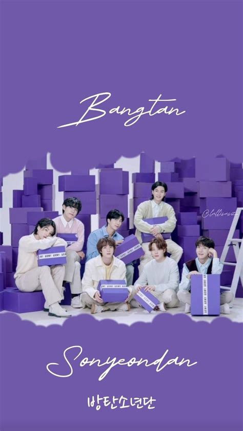 the group is posing for a photo in front of purple boxes with white writing on them