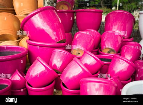 Large bright pink ceramic flower pots stacked at a plant nursery Stock Photo - Alamy