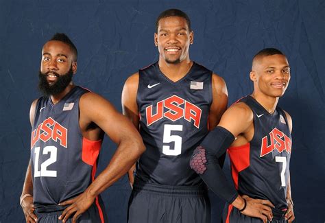 three basketball players pose for a photo in front of a blue background with the usa number five ...