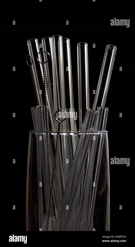 Glass with glass straws and cleaning brush Stock Photo - Alamy