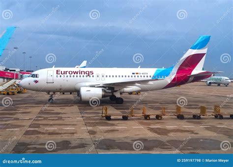 Eurowings Airplane with Empty Luggage Trolleys at the Airport Editorial Stock Photo - Image of ...