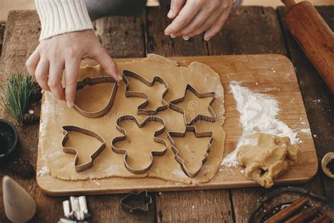 Hand Cutting Gingerbread Dough with Christmas Metal Cutters on Wooden Board, Moody Image. Making ...