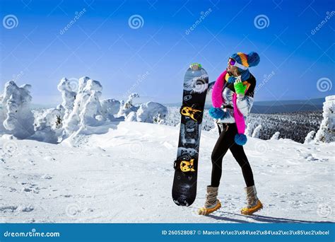 Girl Snowboarder Enjoys the Ski Resort. Beautiful Woman in Winter Outfit is Posing with ...