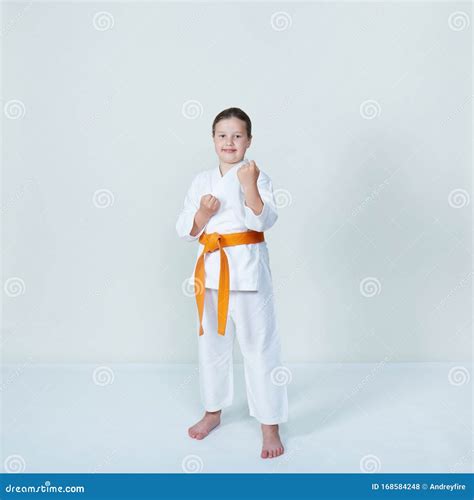 With an Orange Belt Girl Stands in the Rack Karate Stock Photo - Image of beauty, kung: 168584248