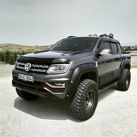 a black truck parked on top of a parking lot