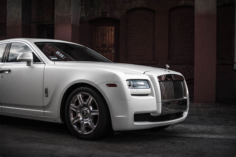 Photo of White Rolls-Royce Ghost Parked Near Brown Building · Free Stock Photo