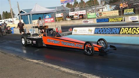 an orange race car driving down a track