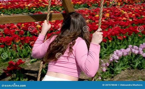 Young Attractive Blond Woman in White Summer Dress Swings on Chain ...