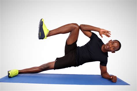 Fit Man Doing Side Plank with Knee Crunch on Yoga Mat. Side Plank ...