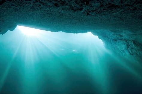 Premium Photo | Large dark underwater cave in ocean in sunlight