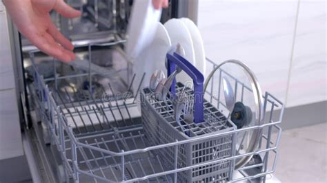 Man Unloading Dishwasher Taking Out White Utensil and Cutlery High Speed. Stock Footage - Video ...