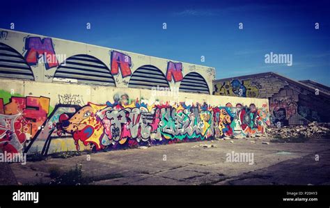 Graffiti wall on old factory Stock Photo - Alamy