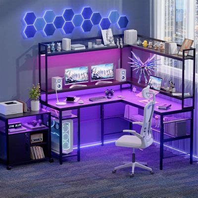 a computer desk with purple lighting in an office space next to a chair ...