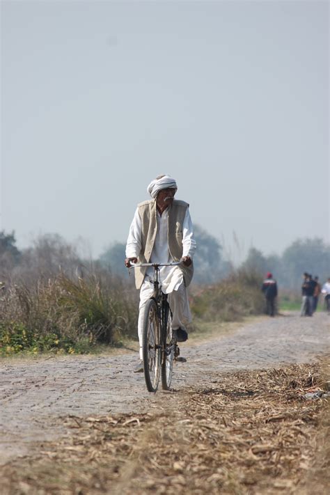 Man in White Long Sleeves Riding Bicycle · Free Stock Photo