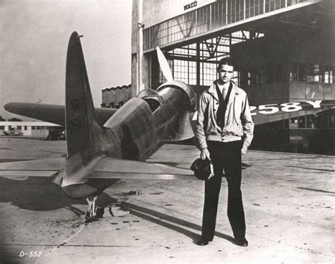 American businessman and aeronautical pioneer Howard Hughes poses with ...