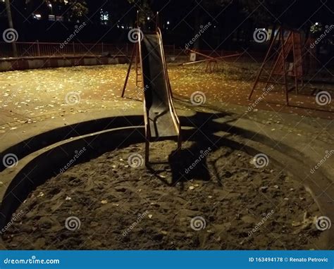 An Empty Playground with a Red Metal Slide at Night and Creepy Atmosphere Stock Photo - Image of ...