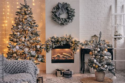 Cosy room decorated, fireplace, Christmas tree in silver snow with ...