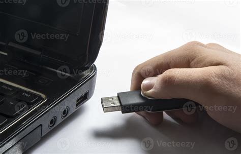 Hand inserting usb memory stick to laptop computer 886895 Stock Photo at Vecteezy