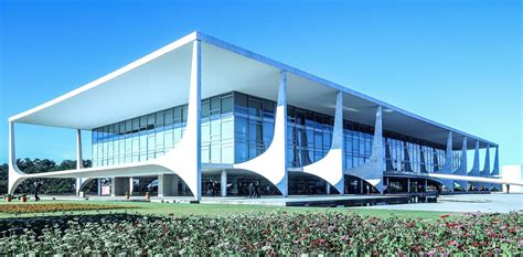 a large building that is next to some bushes