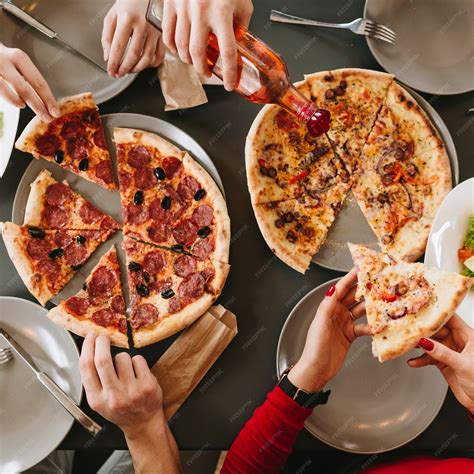 Premium Photo | People eating pizza in a restaurant