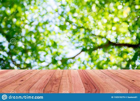 A Picture of a Wooden Desk in Front of an Abstract Tree Background Stock Image - Image of blur ...