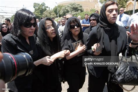 Relatives of Egyptian billionaire Ashraf Marwan, react during his ...