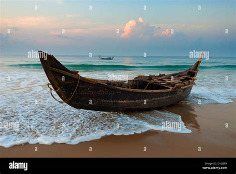 Traditional fishing boat on tide line, Chowara Beach, near Kovalam, Kerala, India, Asia Stock ...