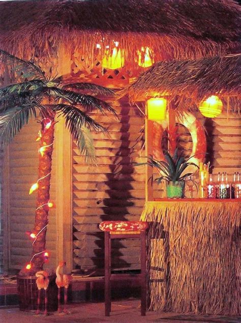 a tiki hut decorated with palm trees and candles