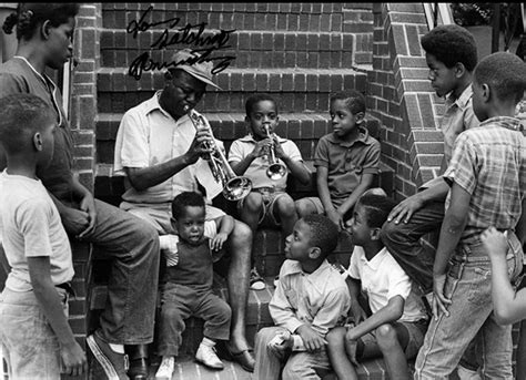 Louis Armstrong with neighborhood kids on the steps of his house in Corona, Queens, 1970. [1070 ...