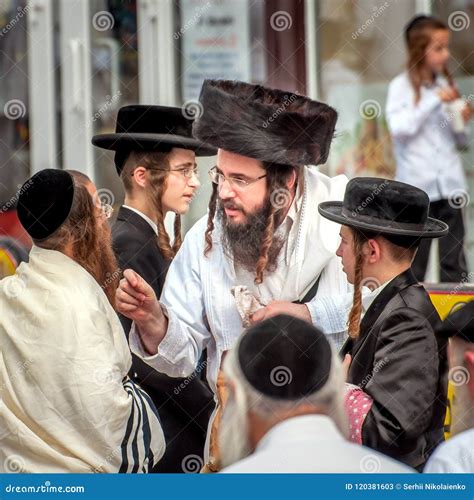 A Group of Hasidim Pilgrims in Traditional Clothing Emotionally Talk ...