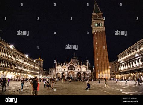 View of St. Mark's Square in Venice at night with lights on inside Stock Photo - Alamy