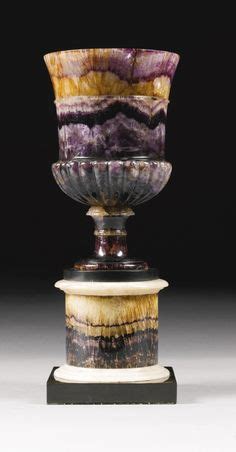 A George III Blue john vase circa 1800, with gadroon carving, on a turned socle and circular ...