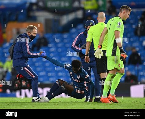 Arsenal's Bukayo Saka receives treatment for an injury during the ...