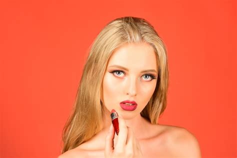 Premium Photo | Blonde girl with lipstick in hand advertising lipstick lip gloss professional ...