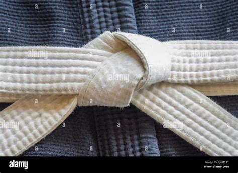 White belt of Brazilian Jiu-Jitsu with four degrees, tied in the kimono, knot of belt Stock ...