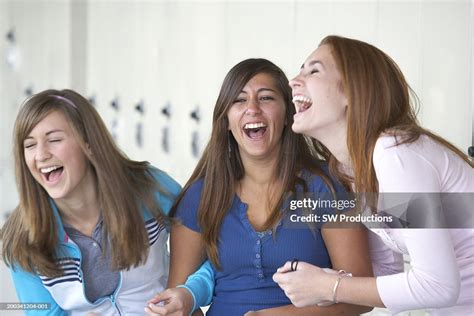 Three Teenage Girls Laughing Beside Lockers In School Corridor High-Res Stock Photo - Getty Images