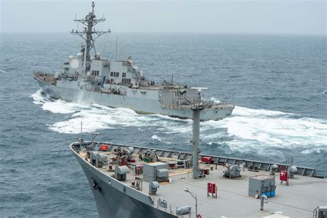 USS Halsey (DDG 97) steams ahead of USNS John Lenthall (T-AO 189) during a replenishment-at-sea ...