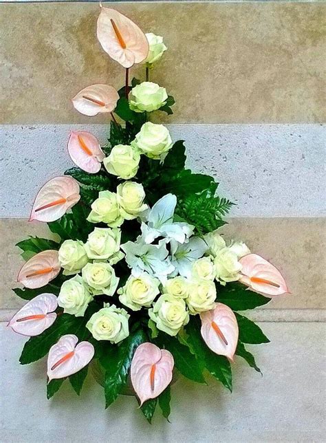 The Anthurium flowers are placed on the outside while the roses are on ...