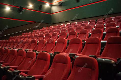 Premium Photo | A movie theater with red seats and a green wall with ...