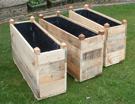 Hand-made wooden troughs and planters made from reclaimed and recycled wood, reducing waste and ...
