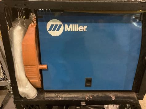 MILLER MILLERMATIC 175 230V WIRE WELDER IN METAL ROLLING CART (MISSING 1 WHEEL) WITH RELATED ...